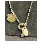 Assorted Silver-Tone Pendant Necklaces with Charms, Beads & Keys in Display Case