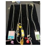 Assorted Silver-Tone Pendant Necklaces with Charms, Beads & Keys in Display Case