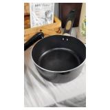 Assorted Kitchenware Items Including Mirro and Revere Ware Pots, T-fal Pan, Rubbermaid Ice Cube Tray, and Decorative Canister