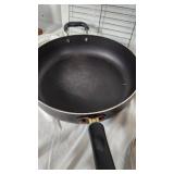 Assorted Kitchenware Items Including Mirro and Revere Ware Pots, T-fal Pan, Rubbermaid Ice Cube Tray, and Decorative Canister