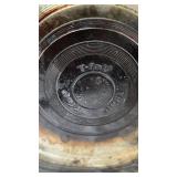 Assorted Kitchenware Items Including Mirro and Revere Ware Pots, T-fal Pan, Rubbermaid Ice Cube Tray, and Decorative Canister