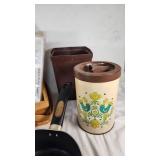 Assorted Kitchenware Items Including Mirro and Revere Ware Pots, T-fal Pan, Rubbermaid Ice Cube Tray, and Decorative Canister