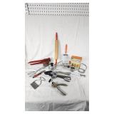 Vintage Kitchen Utensil Collection including Potato Ricer, Rolling Pin, and Hand Mixer