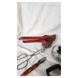 Vintage Kitchen Utensil Collection including Potato Ricer, Rolling Pin, and Hand Mixer