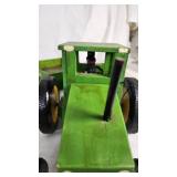 Assorted Toys and Collectibles Including John Deere Tractor, Action Figures, and Accessories