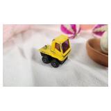 Plush Dog Toy (back legs broken), Yellow Stapler, Easter Egg, and Miscellaneous Items