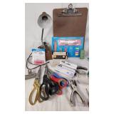 Office supplies including lamp, scissors, rulers, pens, and stencils