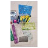 Office supplies including lamp, scissors, rulers, pens, and stencils