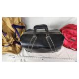 Tan Duffel Bag, Black Leather Bag, and Red Travel Bag