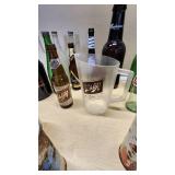 Collection of Vintage Beverage Bottles and Cans Including Miller, Schlitz, 7-Up, and Coca-Cola