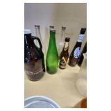 Collection of Vintage Beverage Bottles and Cans Including Miller, Schlitz, 7-Up, and Coca-Cola