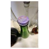 Collection of Vintage Beverage Bottles and Cans Including Miller, Schlitz, 7-Up, and Coca-Cola