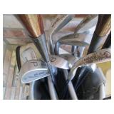 Golf clubs and balls in a golf bag...