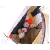 Golf clubs and balls in a golf bag...
