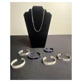 Necklace - Silver Tone Chain with Lot of Cuff Bracelets w Ruler Designs & One w Blue Crystal