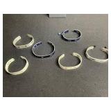 Necklace - Silver Tone Chain with Lot of Cuff Bracelets w Ruler Designs & One w Blue Crystal