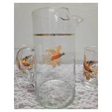 Pitcher with 5 glasses.  These items are likely produced by the "West Virginia Glass" likely from the mid-century era, featuring a distinctive pheasant-in-flight design with gold rim embellishments.