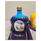 Three upcycled Crown Royal whiskey decanters that appear to be hand painted and decoupaged. The bottles come with Crown Royal velvet bags.The artist signature is Bickford that appears on the decanter.