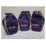 Three upcycled Crown Royal whiskey decanters that appear to be hand painted and decoupaged. The bottles come with Crown Royal velvet bags.The artist signature is Bickford that appears on the decanter.