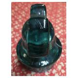 Mickey Mouse glass insulator specifically a CD 257 type manufactured by Hemingray. Were used on power poles to insulate telegraph and telephone wires from the wooden poles holding them.