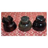 Three Vintage brown ceramic or porcelain electric line insulators, frequently used on railroad or telephone poles to prevent power lines from grounding out.  Used early-to-mid 20th century for railroa