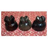 Three Vintage brown ceramic or porcelain electric line insulators, frequently used on railroad or telephone poles to prevent power lines from grounding out.  Used early-to-mid 20th century for railroa