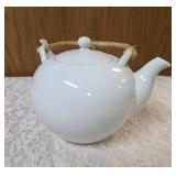 Mikasa fine China white teapot with a lid made of  porcelain with woven bamboo handle.   Mikasa origin is Japan.