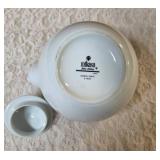 Mikasa fine China white teapot with a lid made of  porcelain with woven bamboo handle.   Mikasa origin is Japan.