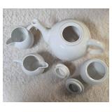 Vintage porcelain tea set featuring a teapot with a rattan handle, a creamer, and a sugar bowl, similar in style to Japanese or German postmodern designs from the mid-to-late 20th century.