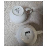 Vintage porcelain tea set featuring a teapot with a rattan handle, a creamer, and a sugar bowl, similar in style to Japanese or German postmodern designs from the mid-to-late 20th century.