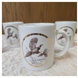 1994 Jerry Raedeke wildlife collector mugs featuring pheasants framed in 22K gold.