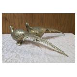 Two vintage brass pheasant figurines. Figurines are solid brass with a polished or natural patina finish and are considered mid-century modern, featuring etched feather detailing.  Approx. 15" long.  