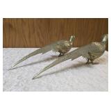 Two vintage brass pheasant figurines. Figurines are solid brass with a polished or natural patina finish and are considered mid-century modern, featuring etched feather detailing.  Approx. 15" long.  
