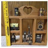 Vintage wood wall hanging shelf featuring a decorative heart cutout and die-cast metal collectibles. Cello, wagon, scale, slot machine, grandfather clock, stove which are pencil sharpeners and a cream
