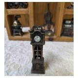 Vintage wood wall hanging shelf featuring a decorative heart cutout and die-cast metal collectibles. Cello, wagon, scale, slot machine, grandfather clock, stove which are pencil sharpeners and a cream