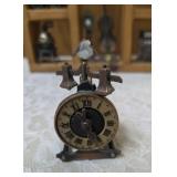 Vintage wood wall hanging shelf featuring a decorative heart cutout and die-cast metal collectibles. Cello, wagon, scale, slot machine, grandfather clock, stove which are pencil sharpeners and a cream