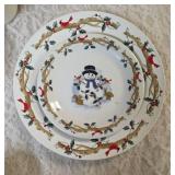 Four piece setting of Home Essentials Woodland Celebration dinnerware set.  Featuring snowman and holly branch patterns.