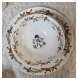 Four piece setting of Home Essentials Woodland Celebration dinnerware set.  Featuring snowman and holly branch patterns.