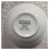 Four piece setting of Home Essentials Woodland Celebration dinnerware set.  Featuring snowman and holly branch patterns.