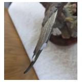 Homco "Majestic Wings" bald10" eagle figurine. It is a porcelain sculpture depicting a bald eagle landing on a rocky mound and is mounted on a dark wooden base with a plaque reading "Majestic Wings". 