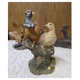 Three -Vintage Resin Figurines and 1 Pheasant on  Wagon Wheel Plate Holder.
