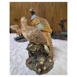Three -Vintage Resin Figurines and 1 Pheasant on  Wagon Wheel Plate Holder.