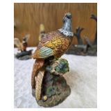 Three -Vintage Resin Figurines and 1 Pheasant on  Wagon Wheel Plate Holder.