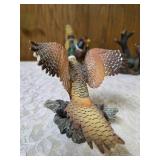 Three -Vintage Resin Figurines and 1 Pheasant on  Wagon Wheel Plate Holder.