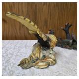Three -Vintage Resin Figurines and 1 Pheasant on  Wagon Wheel Plate Holder.