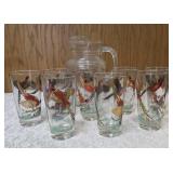 Hazel-Atlas Pitcher and  8  glasses featuring the "Pheasants" pattern. The pitcher is clear, ribbed glass with transferware illustrations of colorful flying pheasants, hunters and dogs.