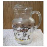 Hazel-Atlas Pitcher and  8  glasses featuring the "Pheasants" pattern. The pitcher is clear, ribbed glass with transferware illustrations of colorful flying pheasants, hunters and dogs.