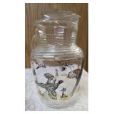 Hazel-Atlas Pitcher and  8  glasses featuring the "Pheasants" pattern. The pitcher is clear, ribbed glass with transferware illustrations of colorful flying pheasants, hunters and dogs.