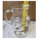Hazel-Atlas Pitcher and  8  glasses featuring the "Pheasants" pattern. The pitcher is clear, ribbed glass with transferware illustrations of colorful flying pheasants, hunters and dogs.