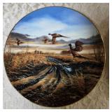 Terry Redland.  Two Terry Redland plate holders  with Two Terry Redland plates. The plates are "Country Road" and "Prairie Skyline".